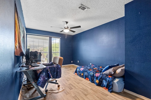 10201 Buffalo Grove Rd, Fort Worth, TX 76108 - bedroom with a textured wall, wood finished floors, an office area, baseboards, and a textured ceiling