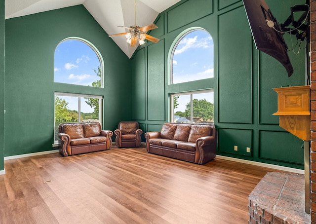 10201 Buffalo Grove Rd, Fort Worth, TX 76108 - living room featuring high vaulted ceiling, ceiling fan, wood finished floors, a decorative wall, and baseboards