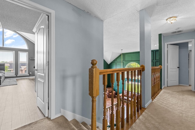 10201 Buffalo Grove Rd, Fort Worth, TX 76108 - corridor with a textured ceiling, lofted ceiling, an upstairs landing, baseboards, and carpet flooring