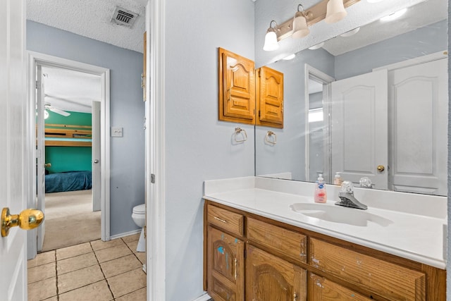 10201 Buffalo Grove Rd, Fort Worth, TX 76108 - bathroom featuring a textured ceiling, toilet, vanity, tile patterned floors, and baseboards