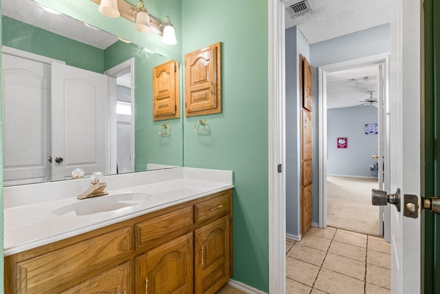 10201 Buffalo Grove Rd, Fort Worth, TX 76108 - bathroom featuring a textured ceiling, tile patterned floors, vanity, ceiling fan, and baseboards