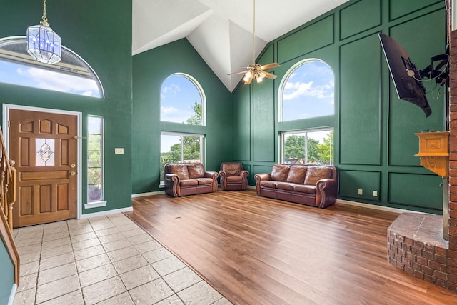 10201 Buffalo Grove Rd, Fort Worth, TX 76108 - entryway with high vaulted ceiling, ceiling fan, a decorative wall, and light wood-style flooring
