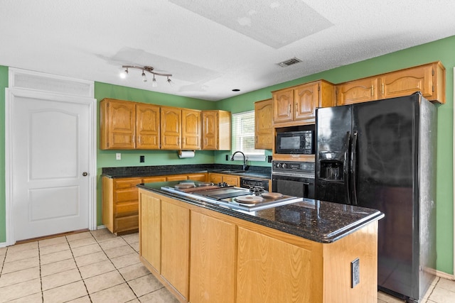 10201 Buffalo Grove Rd, Fort Worth, TX 76108 - kitchen featuring black appliances, a sink, light tile patterned flooring, a kitchen island, and a textured ceiling