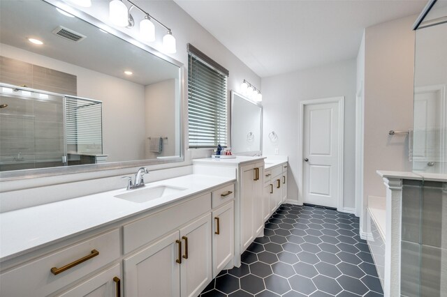 624 Cedarwood St, Little Elm, TX 76227 - full bathroom featuring two vanities, a stall shower, tile patterned floors, a bath, and recessed lighting