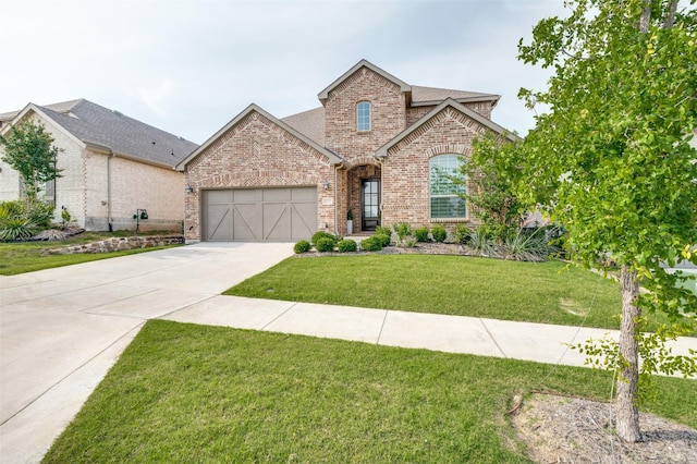 624 Cedarwood St, Little Elm, TX 76227 - view of front facade featuring brick siding, concrete driveway, a garage, a front yard, and a shingled roof