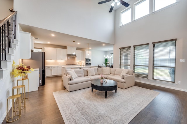 624 Cedarwood St, Little Elm, TX 76227 - living room with a towering ceiling, dark wood finished floors, a ceiling fan, stairs, and recessed lighting