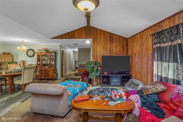living area with vaulted ceiling, a chandelier, wooden walls, wood finished floors, and crown molding