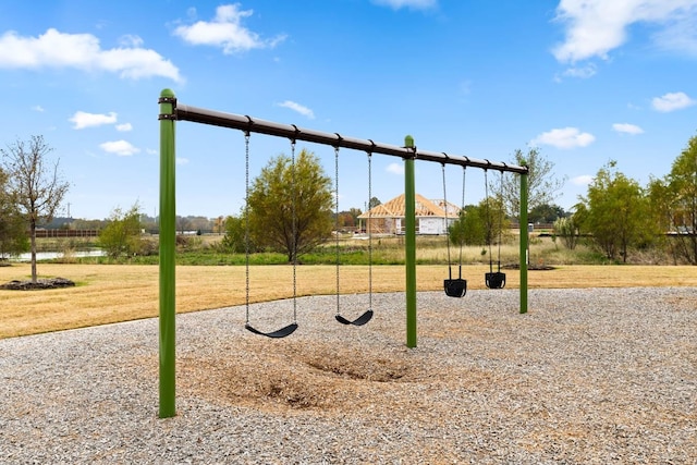 community jungle gym featuring a lawn