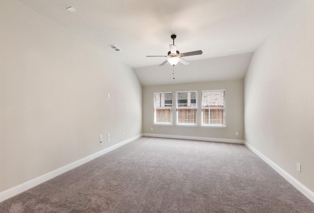 spare room with carpet, a ceiling fan, baseboards, and lofted ceiling