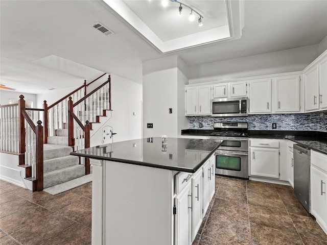 3000 Clearmeadow Dr, Mesquite, TX 75181 - kitchen featuring appliances with stainless steel finishes, dark countertops, backsplash, and white cabinets
