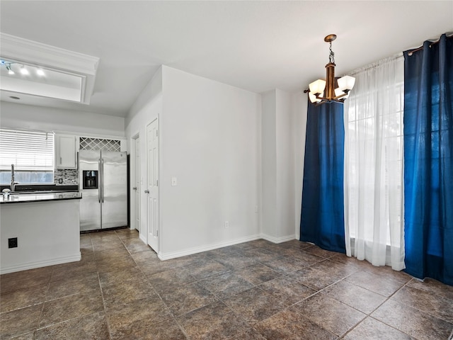 3000 Clearmeadow Dr, Mesquite, TX 75181 - unfurnished dining area featuring a chandelier, baseboards, a sink, and dark stone finish flooring