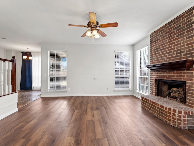 3000 Clearmeadow Dr, Mesquite, TX 75181 - unfurnished living room with a ceiling fan, plenty of natural light, wood-type flooring, and a fireplace