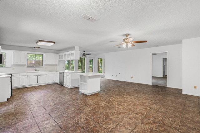 104 Murls Lake Rd, Weatherford, TX 76085 - kitchen featuring open shelves, a ceiling fan, a textured ceiling, light countertops, and a sink