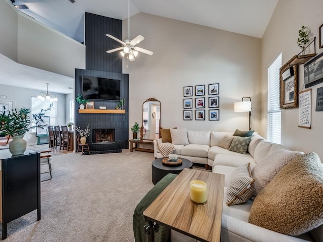 976 Fox Grove Ln, Providence Village, TX 76227 - living area featuring carpet floors, a ceiling fan, a fireplace, high vaulted ceiling, and a chandelier
