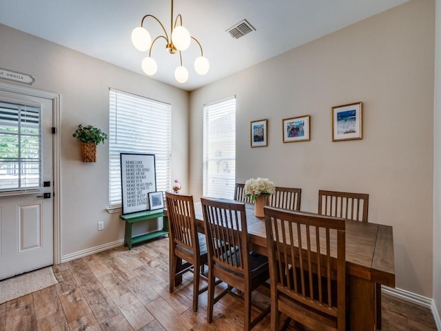 976 Fox Grove Ln, Providence Village, TX 76227 - dining room with a chandelier, wood finished floors, and baseboards