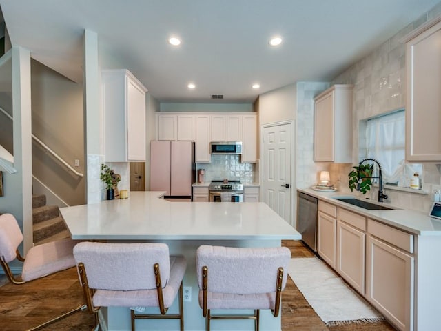 976 Fox Grove Ln, Providence Village, TX 76227 - kitchen featuring stainless steel appliances, a sink, a peninsula, recessed lighting, and tasteful backsplash