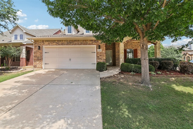 5900 Pansy Rd, Fort Worth, TX 76123 - view of front of home with brick siding, an attached garage, concrete driveway, and a front yard