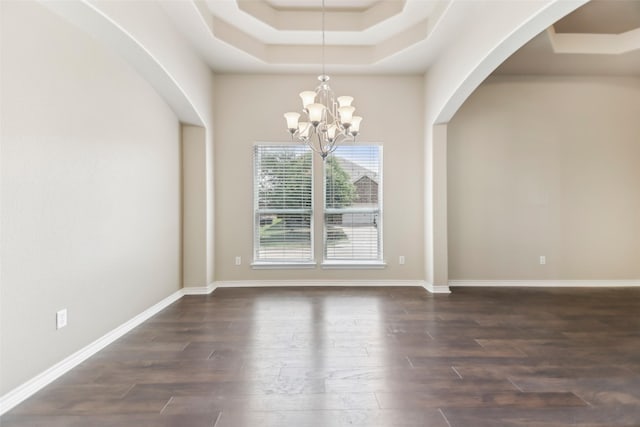5900 Pansy Rd, Fort Worth, TX 76123 - unfurnished dining area featuring a tray ceiling, dark wood-type flooring, a chandelier, and arched walkways