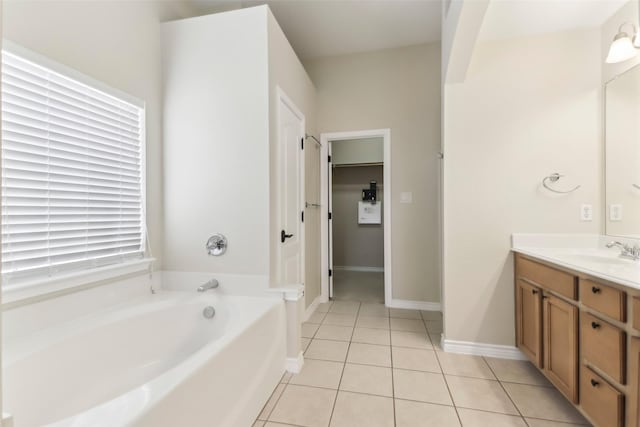 5900 Pansy Rd, Fort Worth, TX 76123 - bathroom featuring tile patterned flooring, a garden tub, vanity, and baseboards