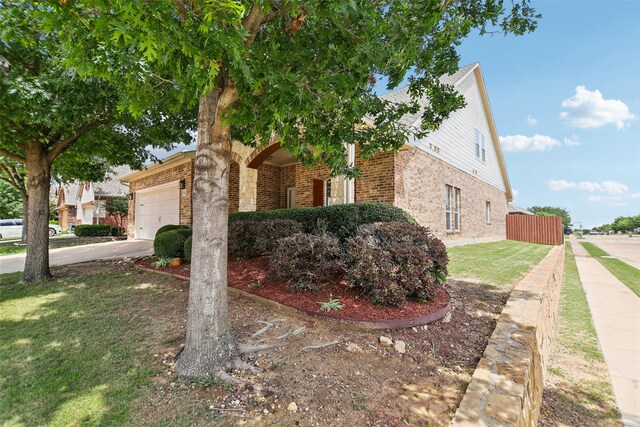 5900 Pansy Rd, Fort Worth, TX 76123 - view of front facade featuring brick siding, a garage, driveway, and a front yard