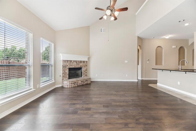 5900 Pansy Rd, Fort Worth, TX 76123 - unfurnished living room featuring ceiling fan, a sink, wood finished floors, baseboards, and high vaulted ceiling