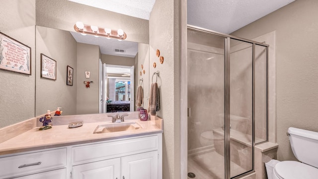 5122 La Vista Ct, Granbury, TX 76049 - bathroom featuring toilet, a textured wall, a textured ceiling, a shower stall, and vanity