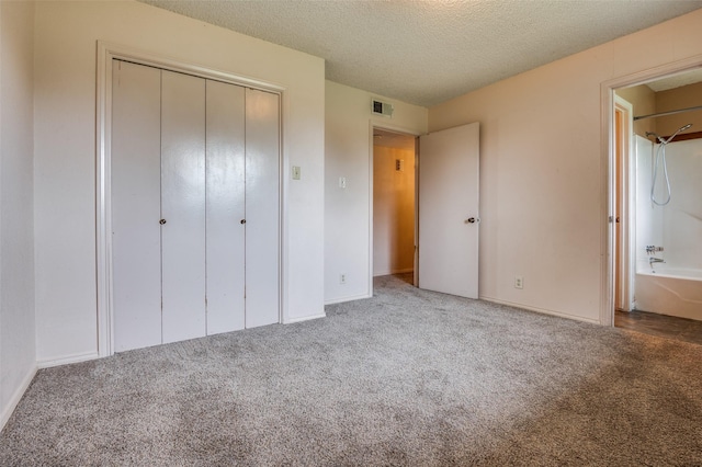 104 Bluebonnet Ln, Palmer, TX 75152 - unfurnished bedroom featuring carpet flooring, a closet, a textured ceiling, and baseboards
