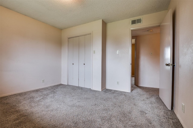 104 Bluebonnet Ln, Palmer, TX 75152 - unfurnished bedroom with carpet floors, a textured ceiling, a closet, and baseboards