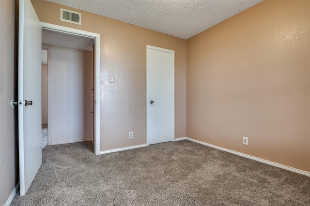 104 Bluebonnet Ln, Palmer, TX 75152 - unfurnished bedroom featuring carpet floors, a textured ceiling, and baseboards
