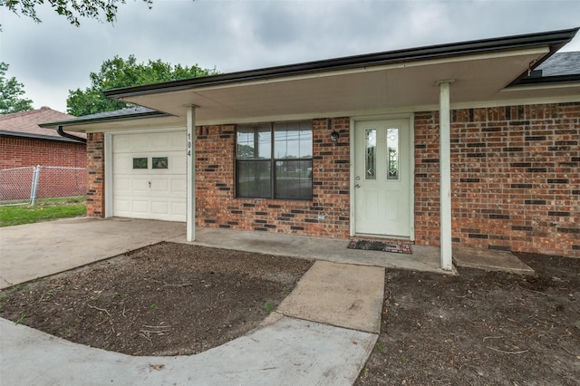 104 Bluebonnet Ln, Palmer, TX 75152 - doorway to property featuring concrete driveway, brick siding, and an attached garage