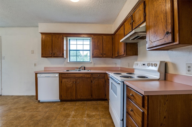 104 Bluebonnet Ln, Palmer, TX 75152 - kitchen featuring white appliances, under cabinet range hood, a sink, a textured ceiling, and brown cabinetry