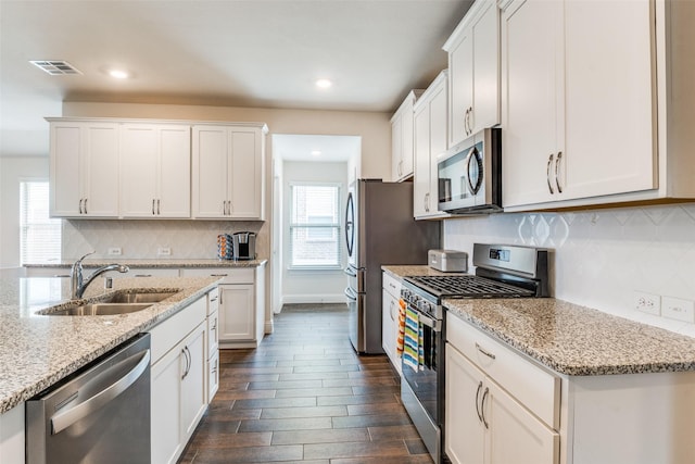 4014 Poplar Dr, Forney, TX 75126 - kitchen with appliances with stainless steel finishes, a sink, dark wood-style floors, white cabinetry, and recessed lighting