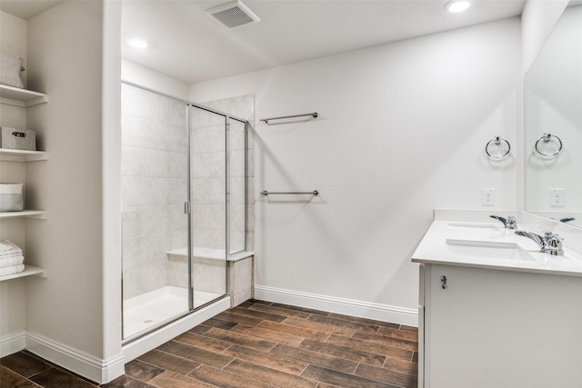 4014 Poplar Dr, Forney, TX 75126 - bathroom with wood tiled floors, a stall shower, baseboards, double vanity, and recessed lighting