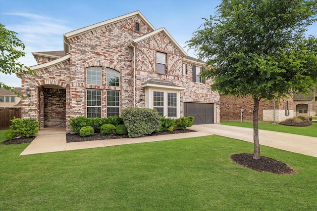 2540 Bottlebrush Dr, Prosper, TX 75078 - view of front of property with an attached garage, driveway, a front lawn, and brick siding
