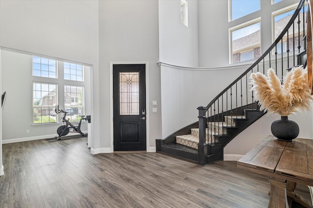 2540 Bottlebrush Dr, Prosper, TX 75078 - foyer featuring a towering ceiling, stairs, wood finished floors, and baseboards
