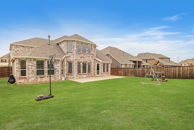 2540 Bottlebrush Dr, Prosper, TX 75078 - rear view of house with a patio area, brick siding, and roof with shingles