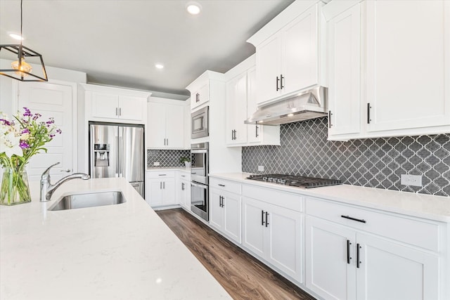 2540 Bottlebrush Dr, Prosper, TX 75078 - kitchen with a sink, under cabinet range hood, appliances with stainless steel finishes, white cabinetry, and tasteful backsplash