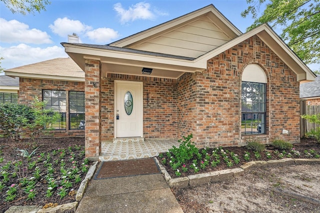 8805 Wood Glen Dr, Rowlett, TX 75088 - view of exterior entry with brick siding and a chimney