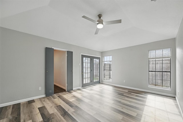 8805 Wood Glen Dr, Rowlett, TX 75088 - unfurnished room with wood finished floors, a ceiling fan, baseboards, lofted ceiling, and french doors