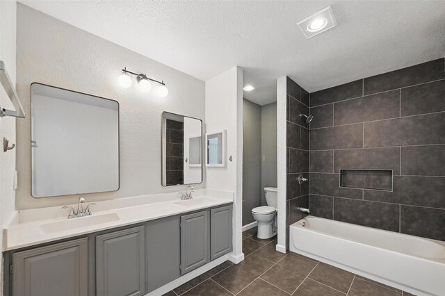 8805 Wood Glen Dr, Rowlett, TX 75088 - full bath with toilet, a textured ceiling, tile patterned floors, double vanity, and shower / bath combination