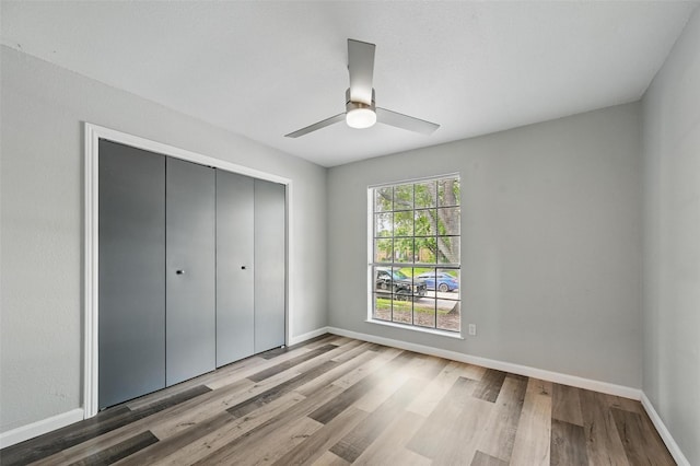 8805 Wood Glen Dr, Rowlett, TX 75088 - unfurnished bedroom with wood finished floors, a closet, and baseboards