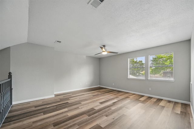 8805 Wood Glen Dr, Rowlett, TX 75088 - spare room with a ceiling fan, wood finished floors, a textured ceiling, and baseboards