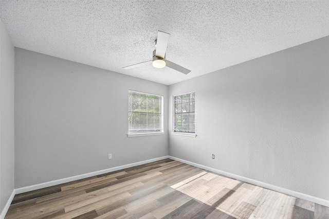 8805 Wood Glen Dr, Rowlett, TX 75088 - unfurnished room with wood finished floors, a ceiling fan, baseboards, and a textured ceiling