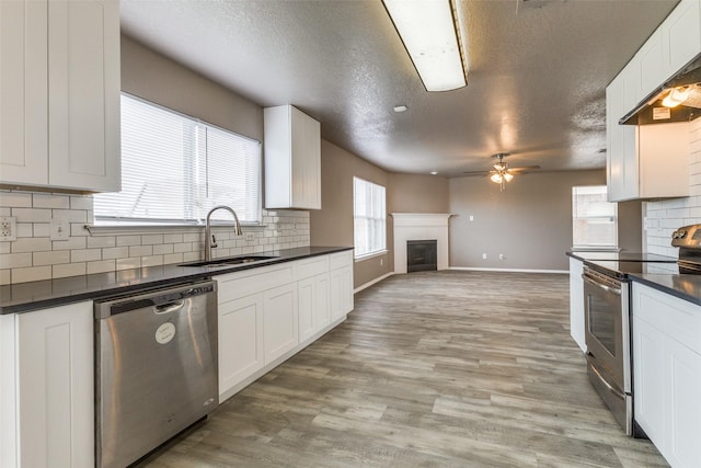 4032 Red Rock, Heartland, TX 75126 - kitchen with appliances with stainless steel finishes, a sink, dark countertops, a textured ceiling, and ceiling fan