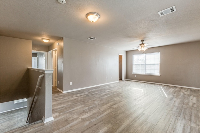 4032 Red Rock, Heartland, TX 75126 - empty room featuring a textured ceiling, wood finished floors, ceiling fan, and baseboards