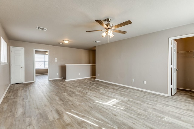 4032 Red Rock, Heartland, TX 75126 - unfurnished living room featuring ceiling fan, light wood finished floors, and baseboards