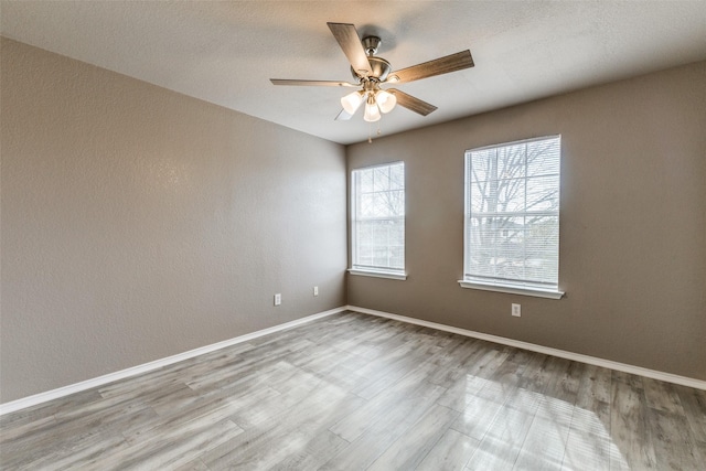 4032 Red Rock, Heartland, TX 75126 - unfurnished room featuring wood finished floors, a ceiling fan, and baseboards