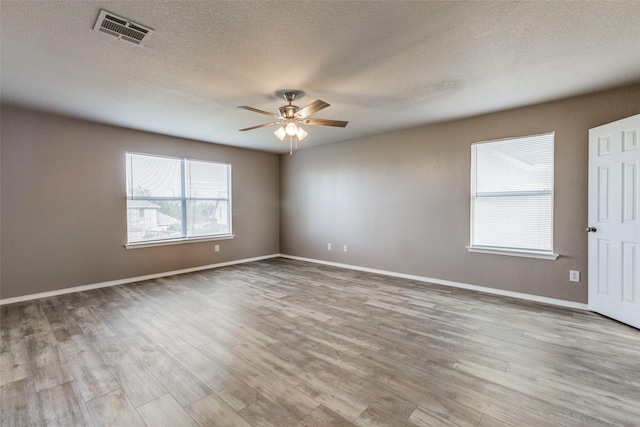 4032 Red Rock, Heartland, TX 75126 - empty room featuring ceiling fan, wood finished floors, baseboards, and a textured ceiling