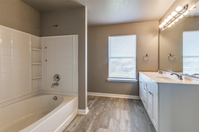 4032 Red Rock, Heartland, TX 75126 - bathroom with wood finished floors, double vanity, a textured ceiling, and baseboards