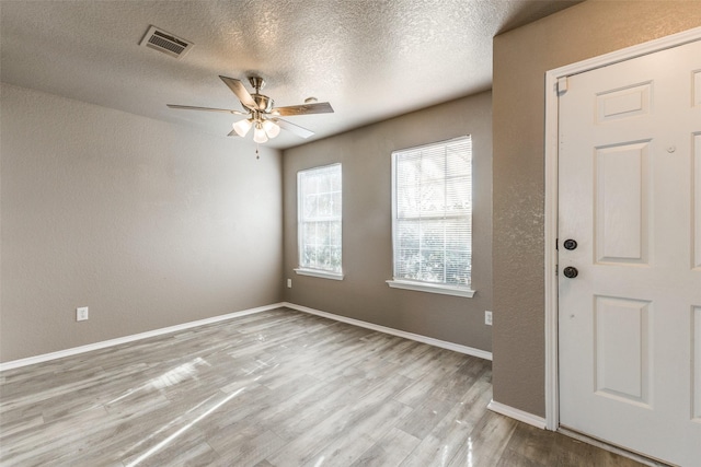 4032 Red Rock, Heartland, TX 75126 - unfurnished room with wood finished floors, ceiling fan, a textured ceiling, a textured wall, and baseboards
